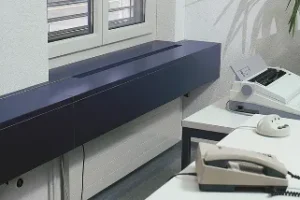 desk-mounted electrical power trunking system in office workspace