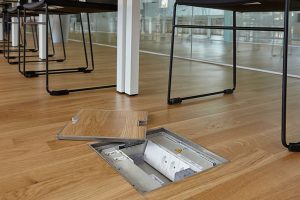 floor box with electrical power outlets in office workspace